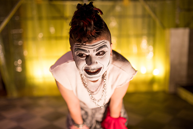A teenager in heavy stage makeup onstage