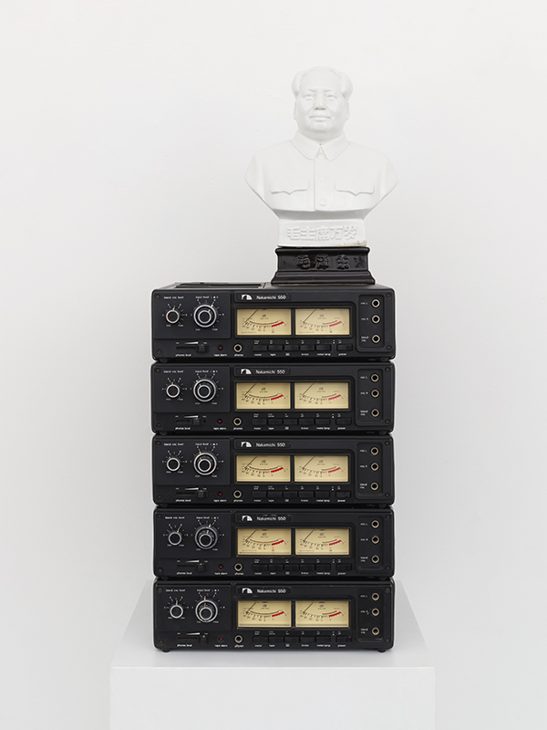 Bust of Chairman Mao on top of five cassette recorders.