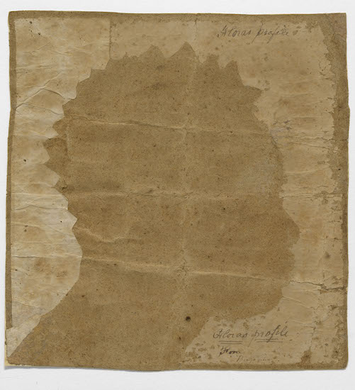 silhouette of head of an African American woman traced on brown paper