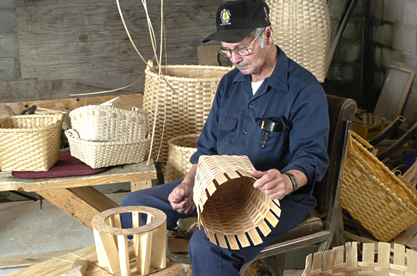 Henry Arquette working on a basket in his workshop