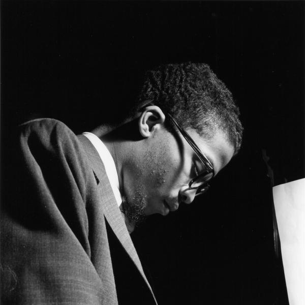 African-American man wearing glasses at the piano. 