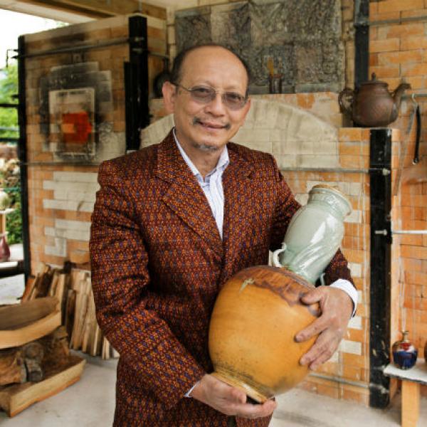 Man holding ceramic vase