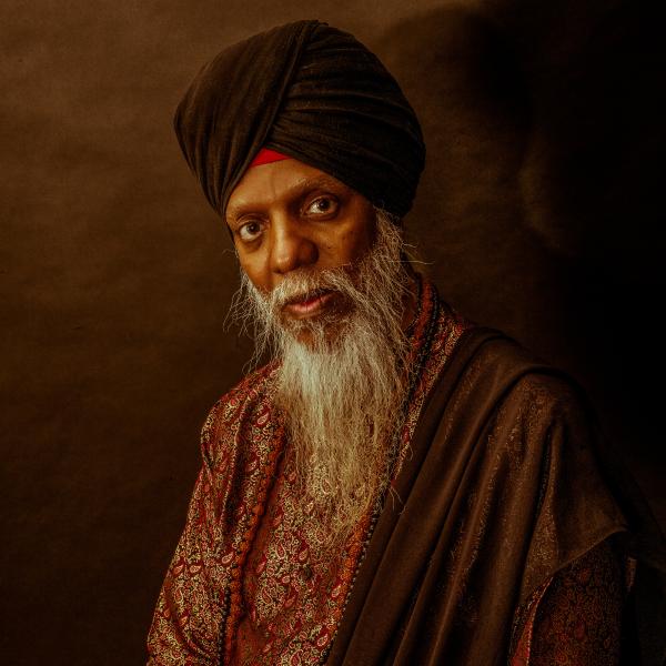 Portrait of man in turban with white beard. 