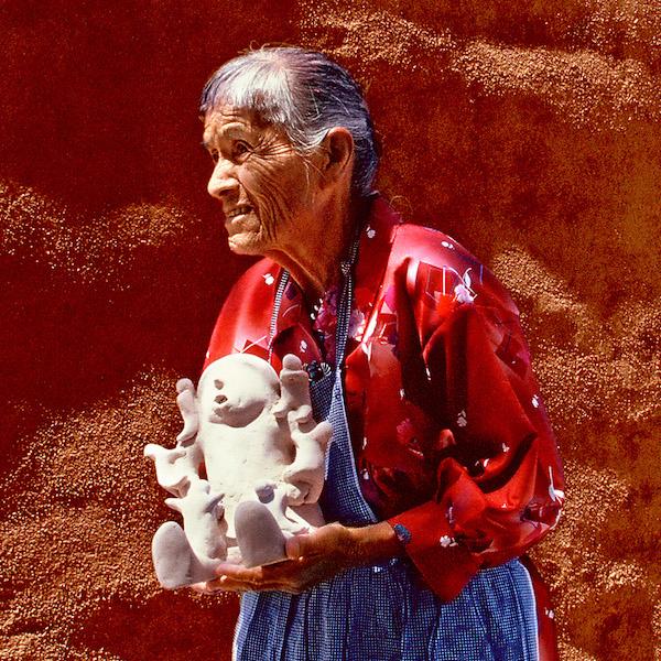 A wman holding a sculture ceramic vasse.