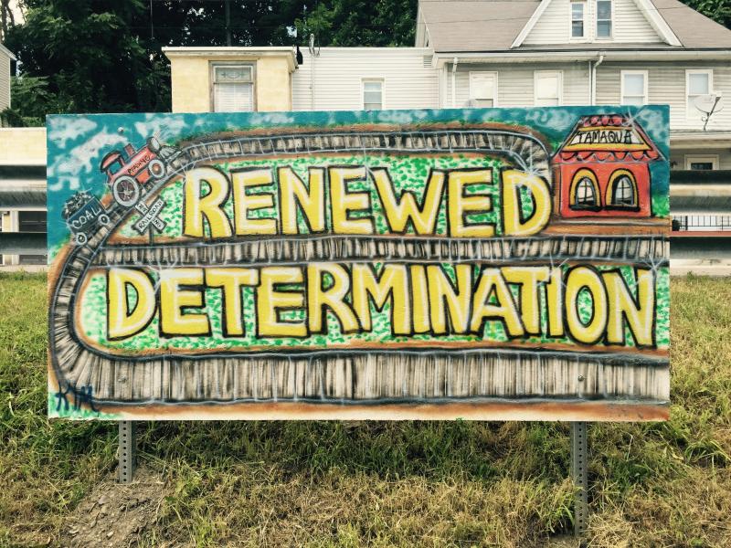 A painted sign that says Renewed Determination