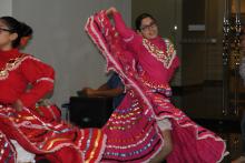 Young Hispanic girl dancing in traditional attire.