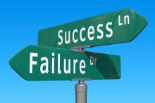 Cross-signs pointing in different directions with one direction saying "success lane" and the other direction "failure drive."