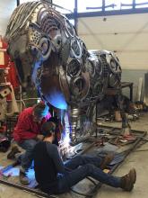 Students building a metal horse sculpture