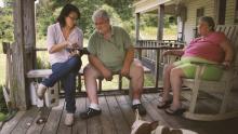 Filmmaker Jennifer Crandall on a porch with two older white people