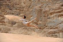 dancer leaping in the air in the desert