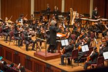 A student orchestra performs on a stage