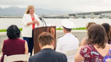 Mary Anne Carter delivers remarks against backdrop of Pearl Harbor