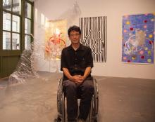 man in wheelchair in an art gallery.
