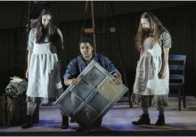 Three characters from Missy Mazzoli's Proving up, including one man who is kneeling flanked by two young women.