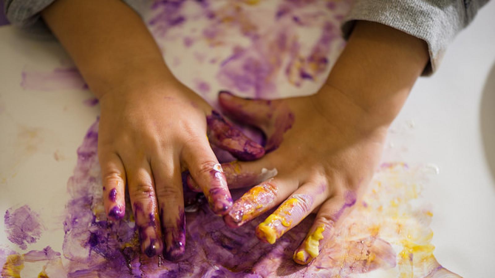 A child's hands with fingerpaint