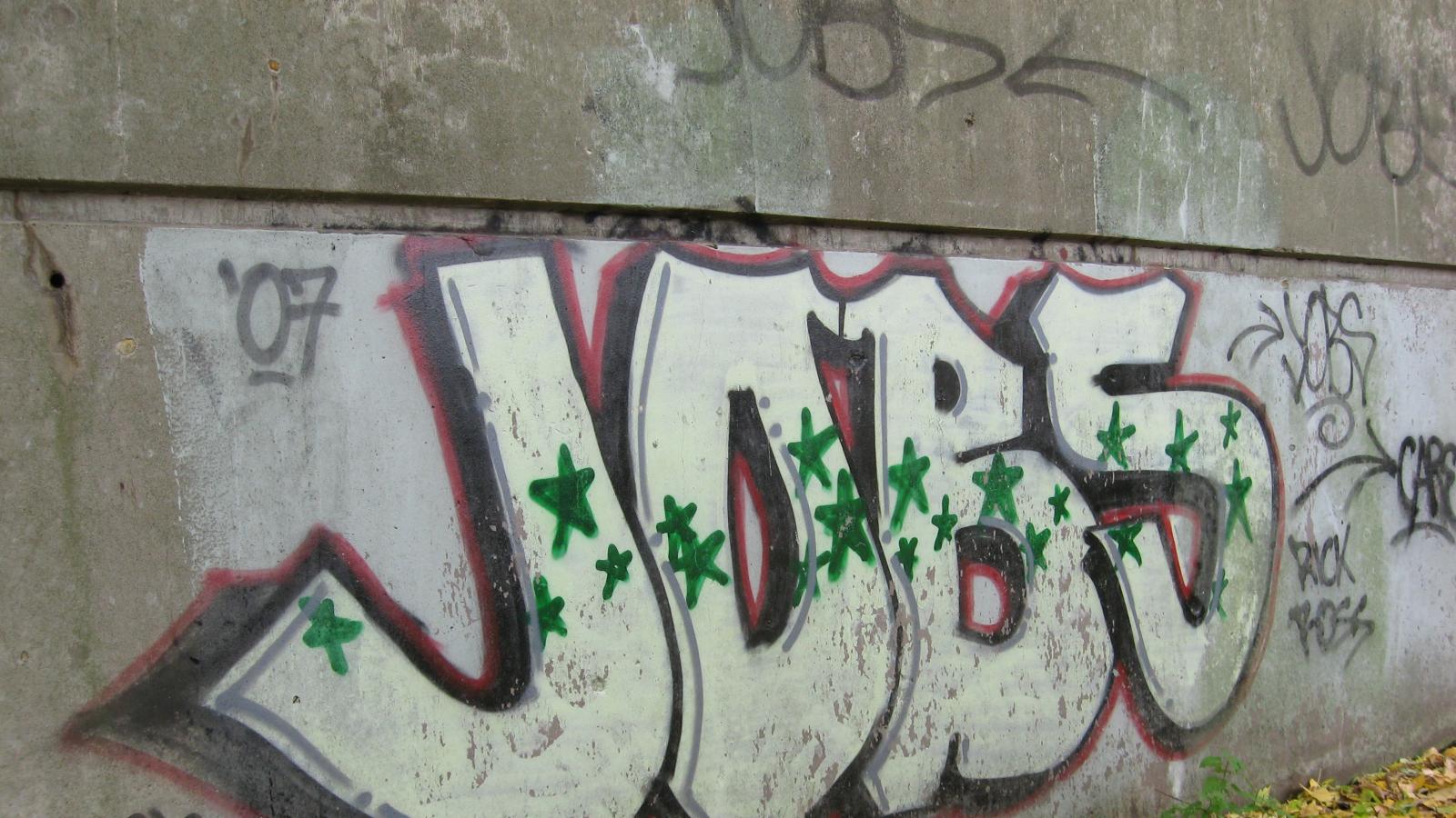 graffiti on a wall that says jobs