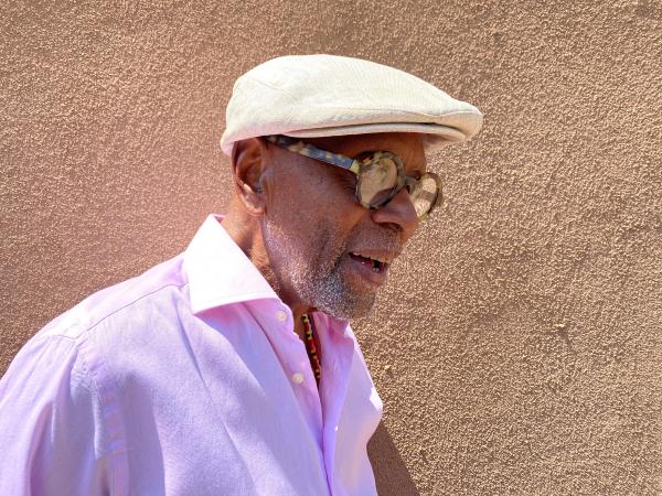 Portrait of man in cap wearing glasses. 