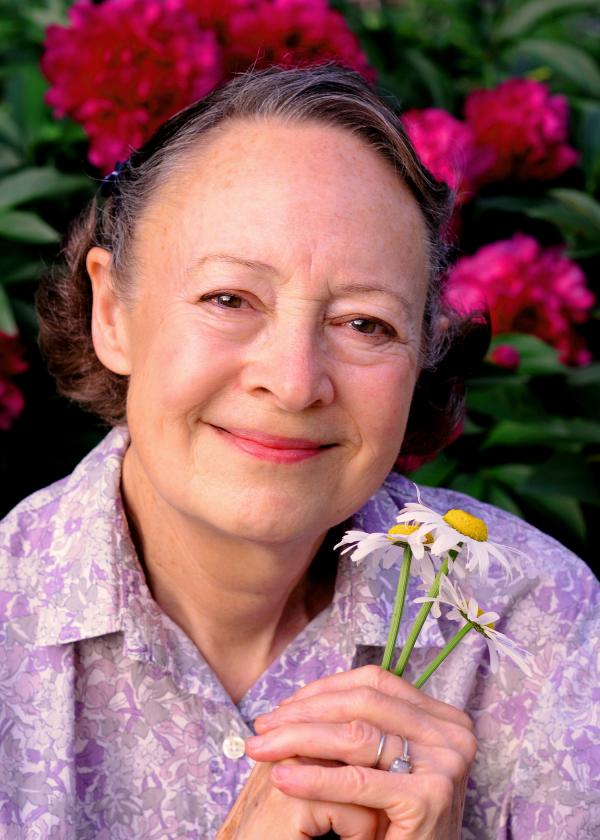 Portrait of woman holding flowers.
