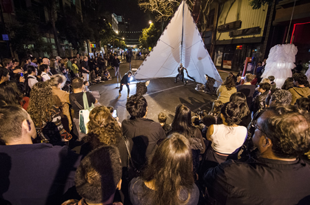 Crowd at an outdoor place watching a nighttime street performance