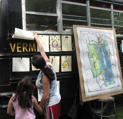 Residents of Brookside Mobile Home Park in Starksboro look at the signs created by the park&#039;s children during Matthew Perry&#039;s residency.