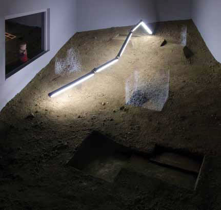 Installation of a illuminated pipe in a room with dirt covered floor