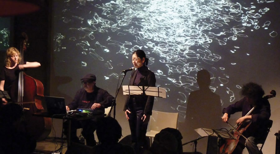 Pearl Alexander, Carl Stone, Makiko Sakurai, and Hiromichi Sakamoto performing Stone&#039;s composition &quot;Darda,&quot; a &quot;digital prayer&quot; for the victims of the 2011 earthquake in Japan, performed in Tokyo in May 2011