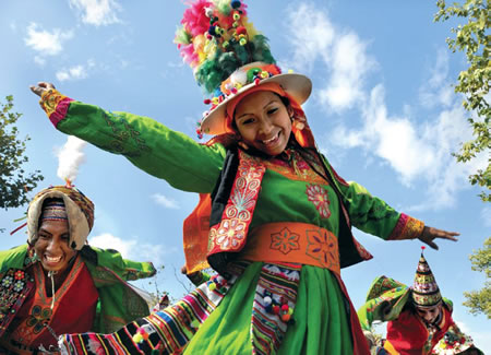 Woman in elaborate headdress, vest and dress marching in parade