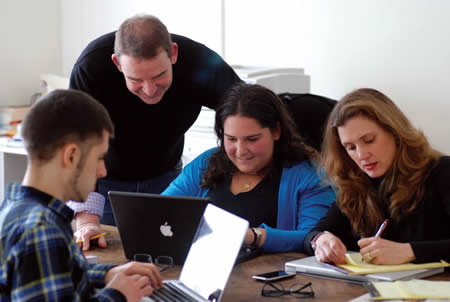 four people at a table in a meeting 