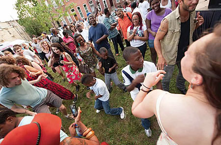 Group of people of all ages dancing in a park