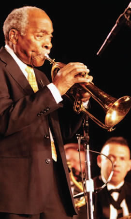 Jazz musician on stage playing trumpet