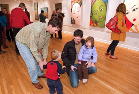 Adults and children at a gallery 