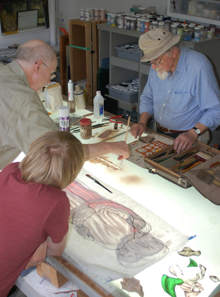 Andy Young assists John Nussbaum in a demonstration of stained-glass painting techniques at the Pearl River Glass Studio in the Midtown Arts District of Jackson, Mississippi. Photo by Tom Crouch