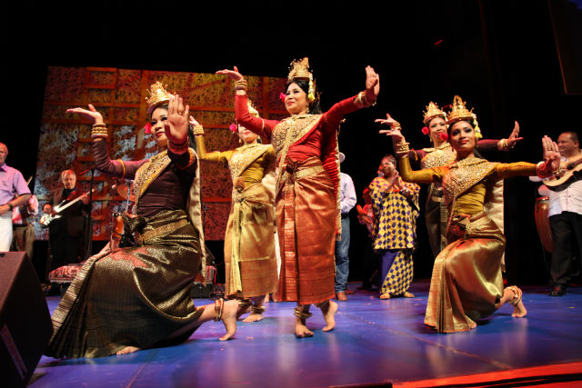 Women dance while wearing traditional Cambodian attire