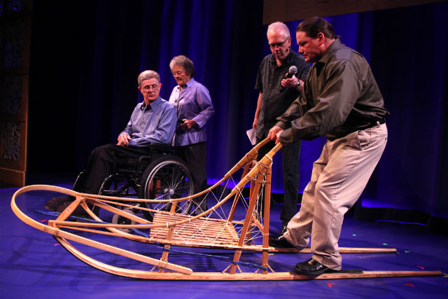 A man demonstrates how to use a dogsled