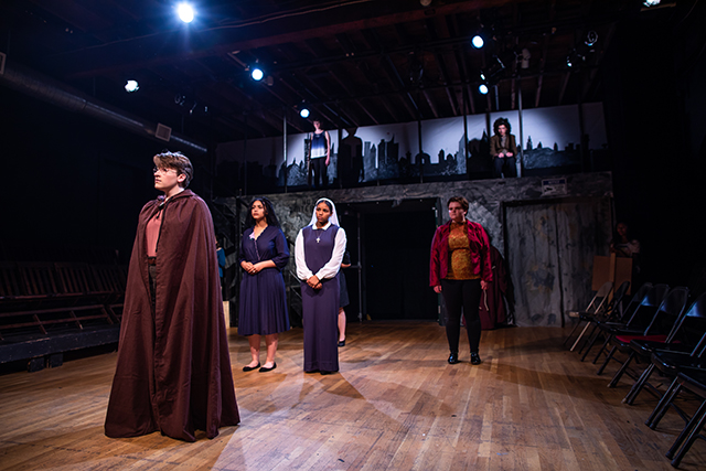 Teens in costumes perform in a play