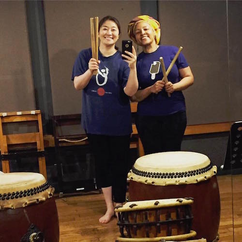 Ai Matsuda and Latasha Diggs take a selfie with some taiko drums
