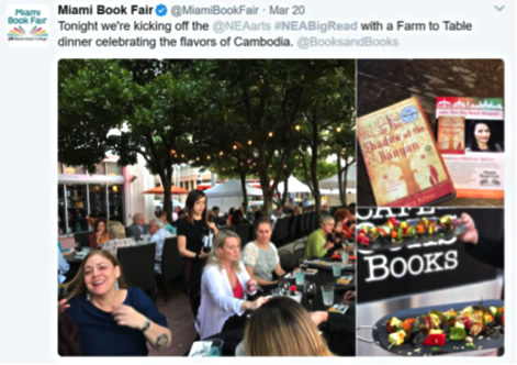 Screen capture from Twitter. Large outdoor banquet with two long tables. There are trees with string lights. 