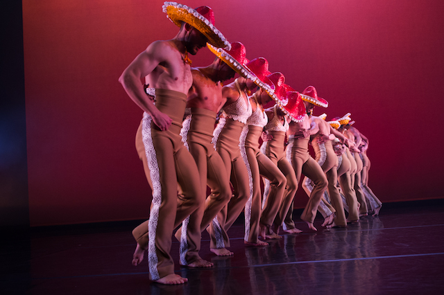 a line of dancers onstage in Michelle Manzanales' ballet Con Brazos Abiertos