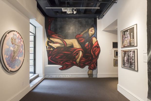 gallery view of graffiti-inspired portrait of a woman who seems to be leaning against a wall in sitting position