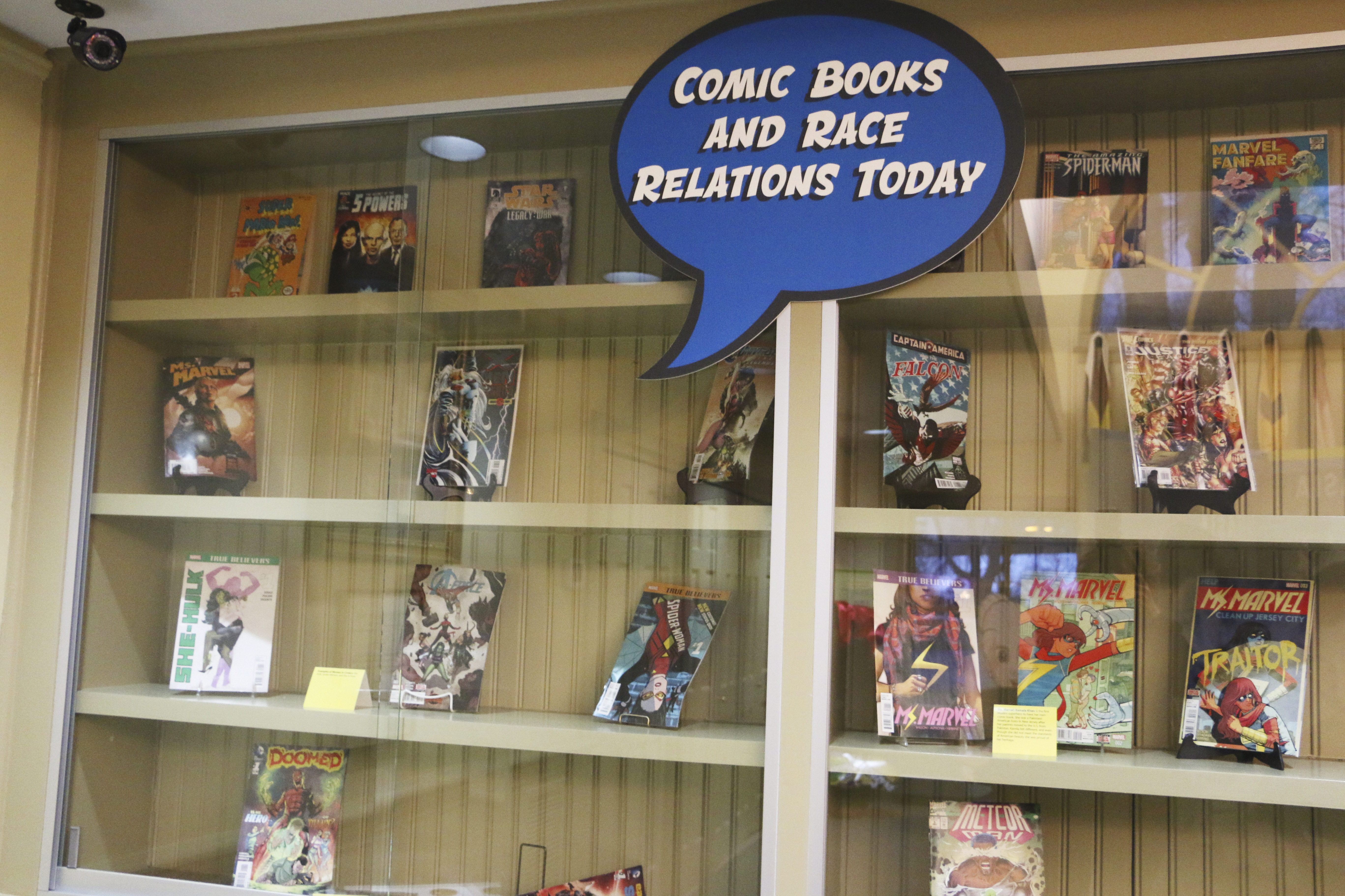 Comic books behind a glass exhibit.