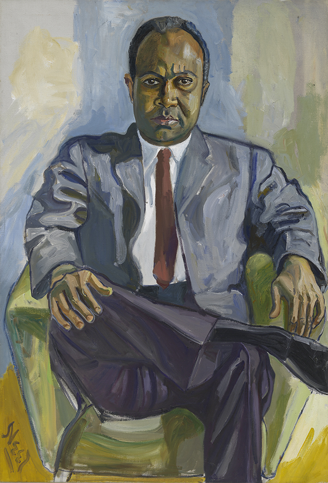 Portrait of African American man sitting cross legged in a chair