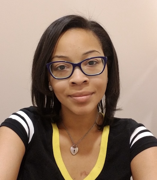 a young African American woman with glasses