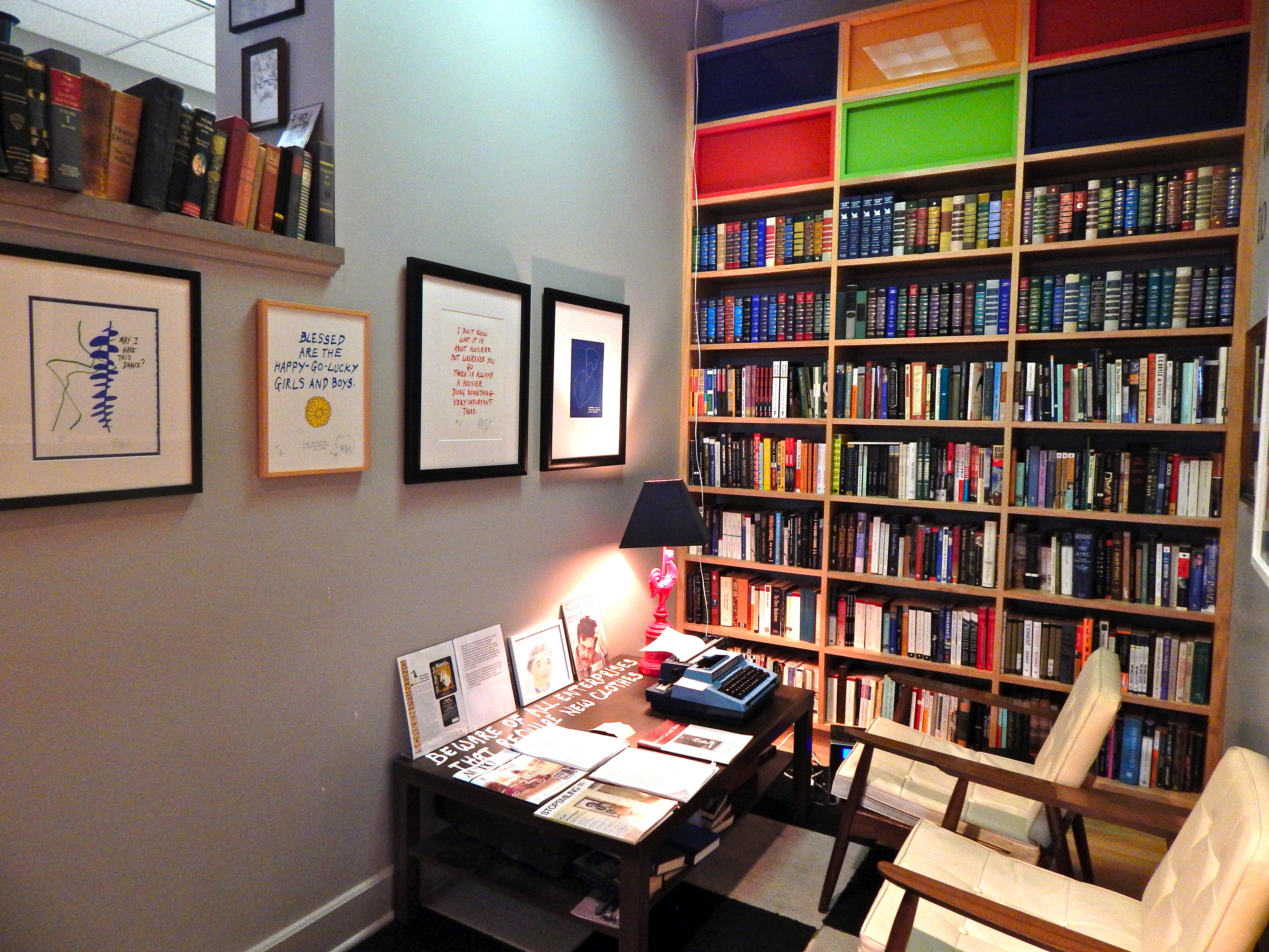 Kurt Vonnegut's study, which includes his desk, a bookshelf, and his red rooster lamp.