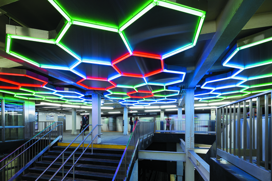 A multi-colored series of neon squares installed on a ceiling