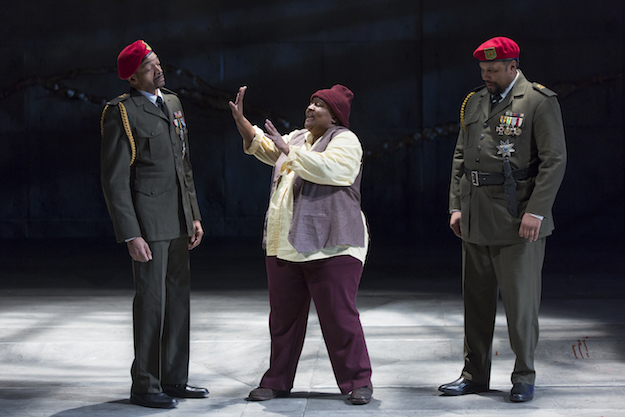 two African-American men in military uniforms on either side of a casually dressed African American woman with whom they're having a conversation