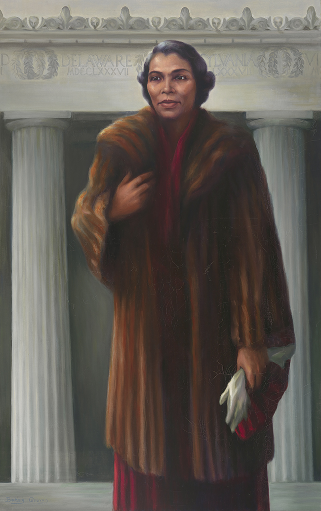 Portrait of an African American woman wearing a fur coat and standing in front of Lincoln Memorial