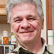 Headshot of a man with white hair.