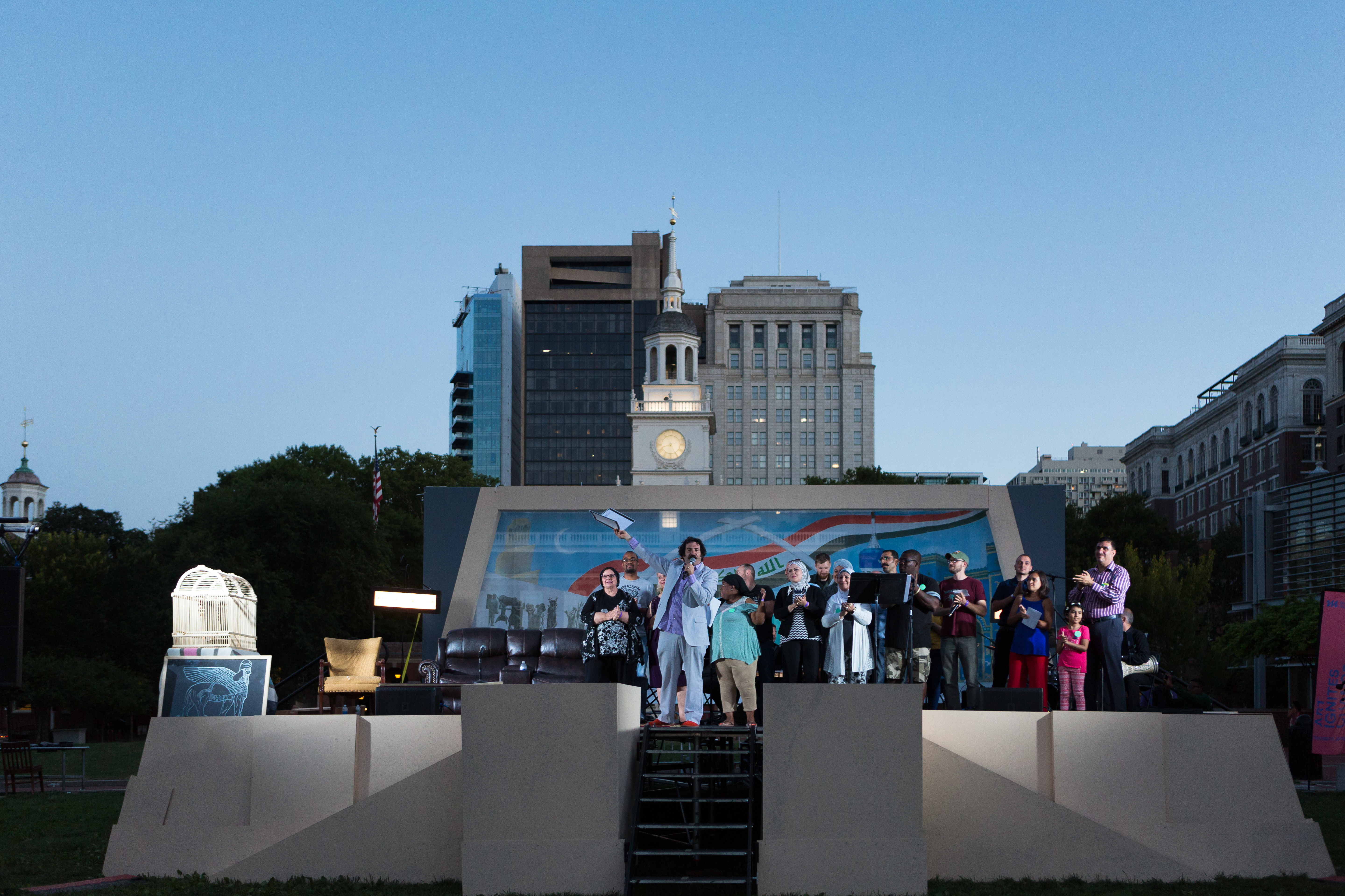 A man on an outdoor stage in front of Independence Hall in Philadelphia with people behind him