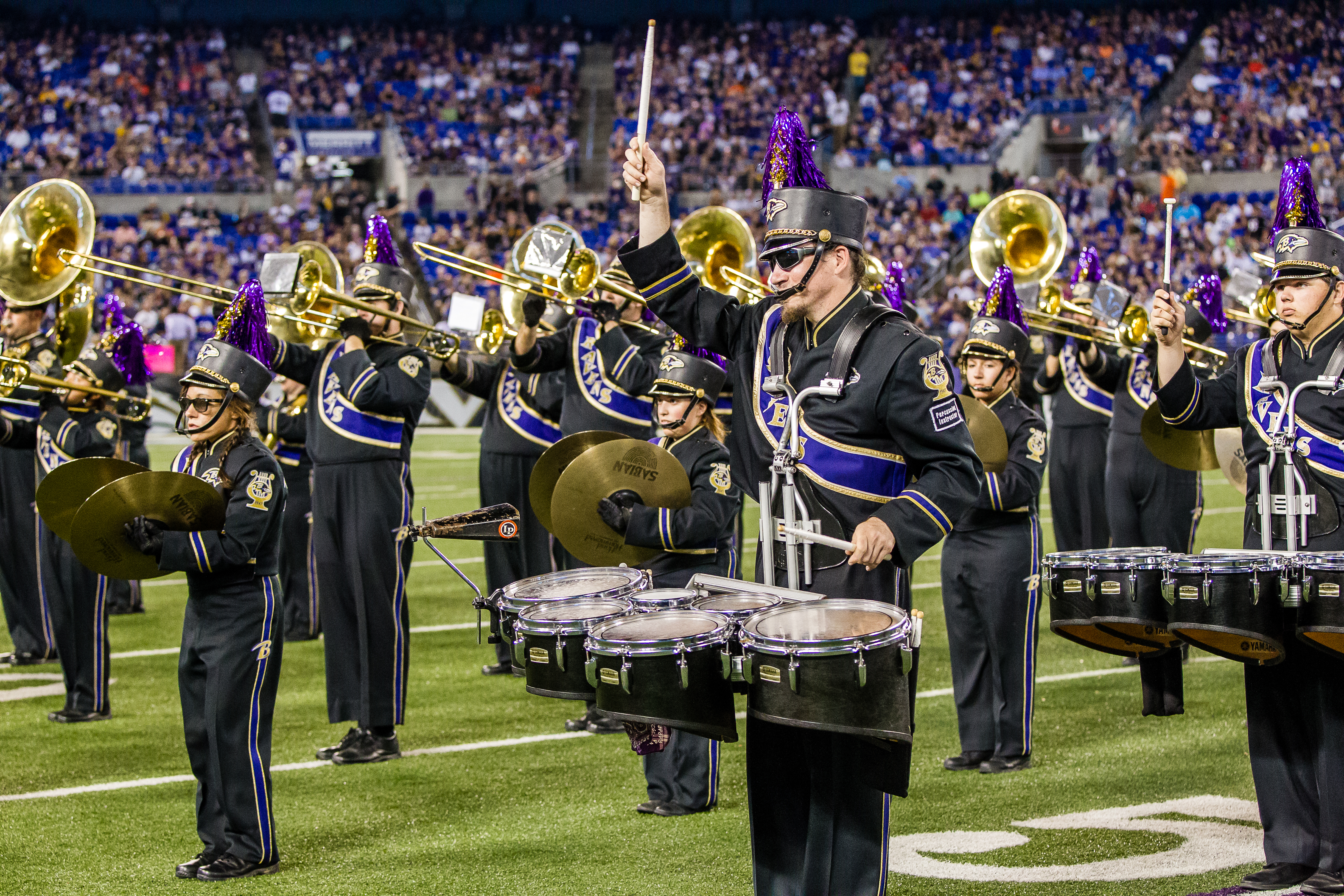 A marching band playing their instruments. 