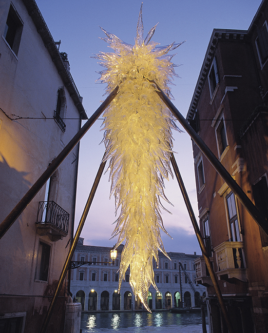 Yellow glass artwork hanging over Venice canal. 